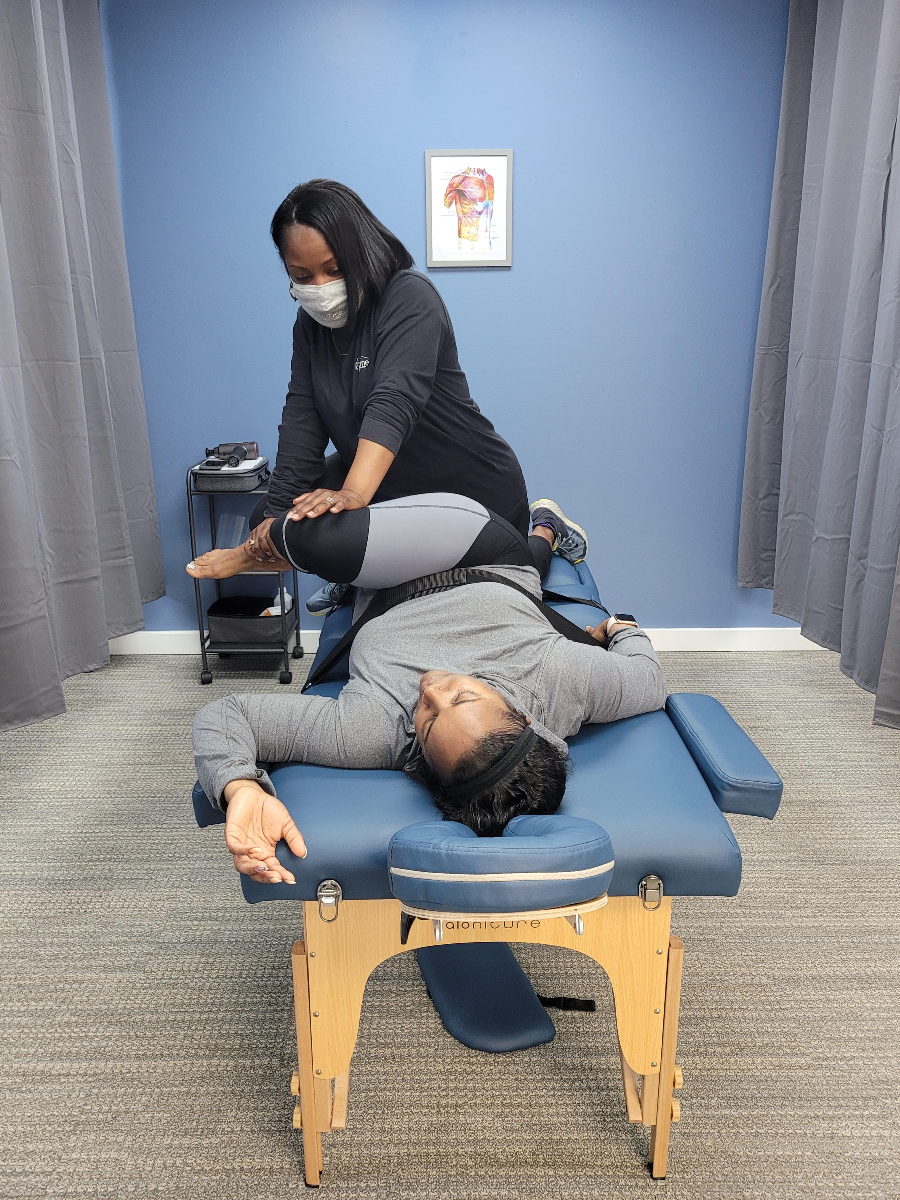 Practitioner performing sciatica relief stretch therapy at Knot Me